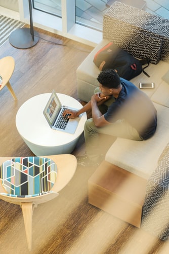 A glimpse from above offers a view of a biophilic designed office equipped with ASI Architectural acoustic ceiling paneling.