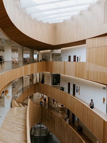 A library atrium equipped with ASI Architectural acoustic wooden paneling and ceiling tiles.