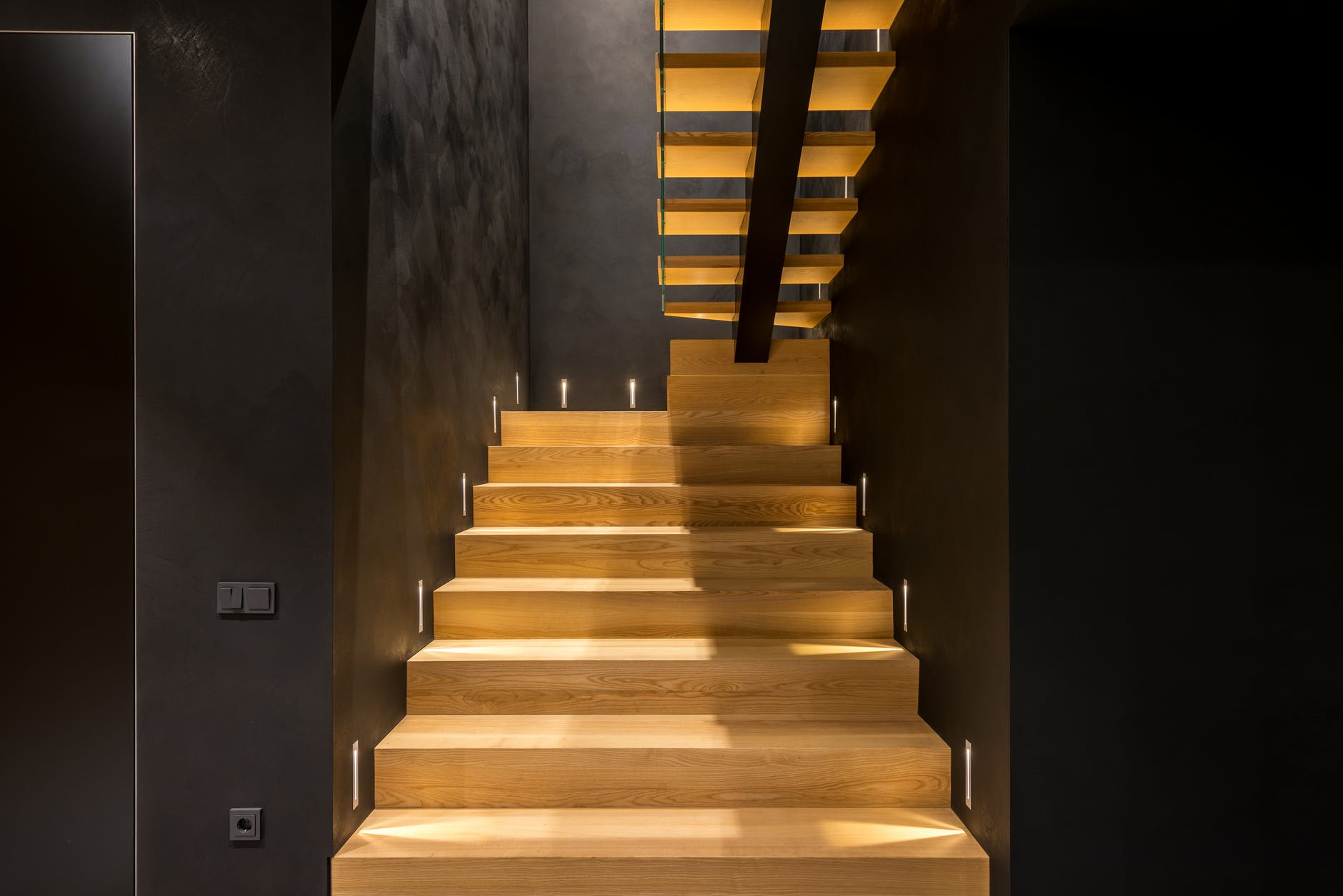 A modern stair case features acoustic timber architecture installed by ASI Architectural