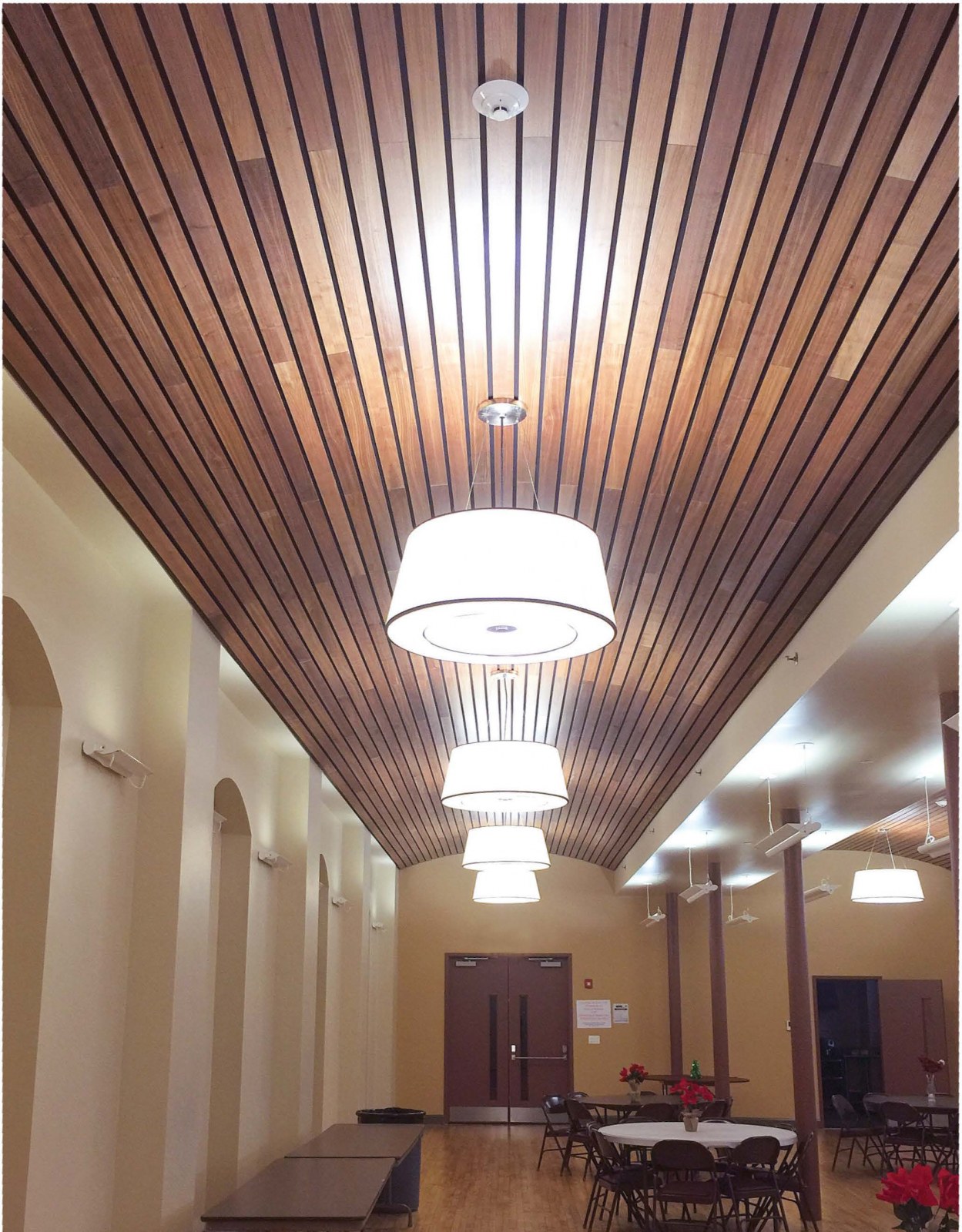 A conference room features wooden linear ceiling solutions by ASI Architectural