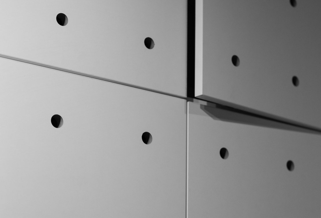 A close up view of white micro perforated metal metals made by ASI Architectural.