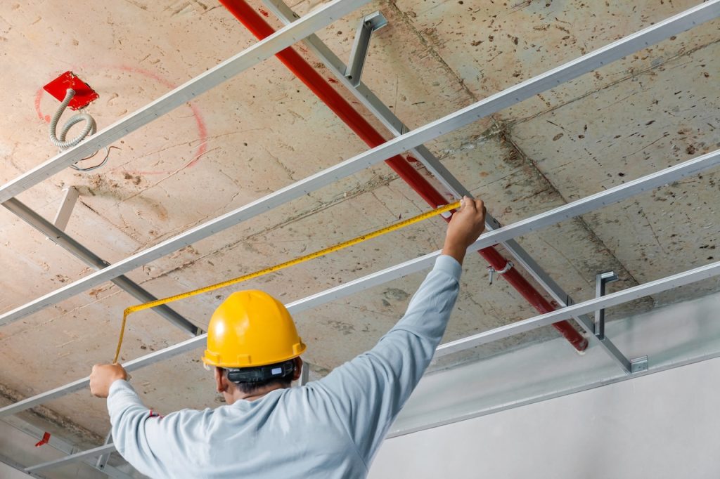Measuring distance and planning the armstrong ceiling installation with acoustic panels With professional technicians