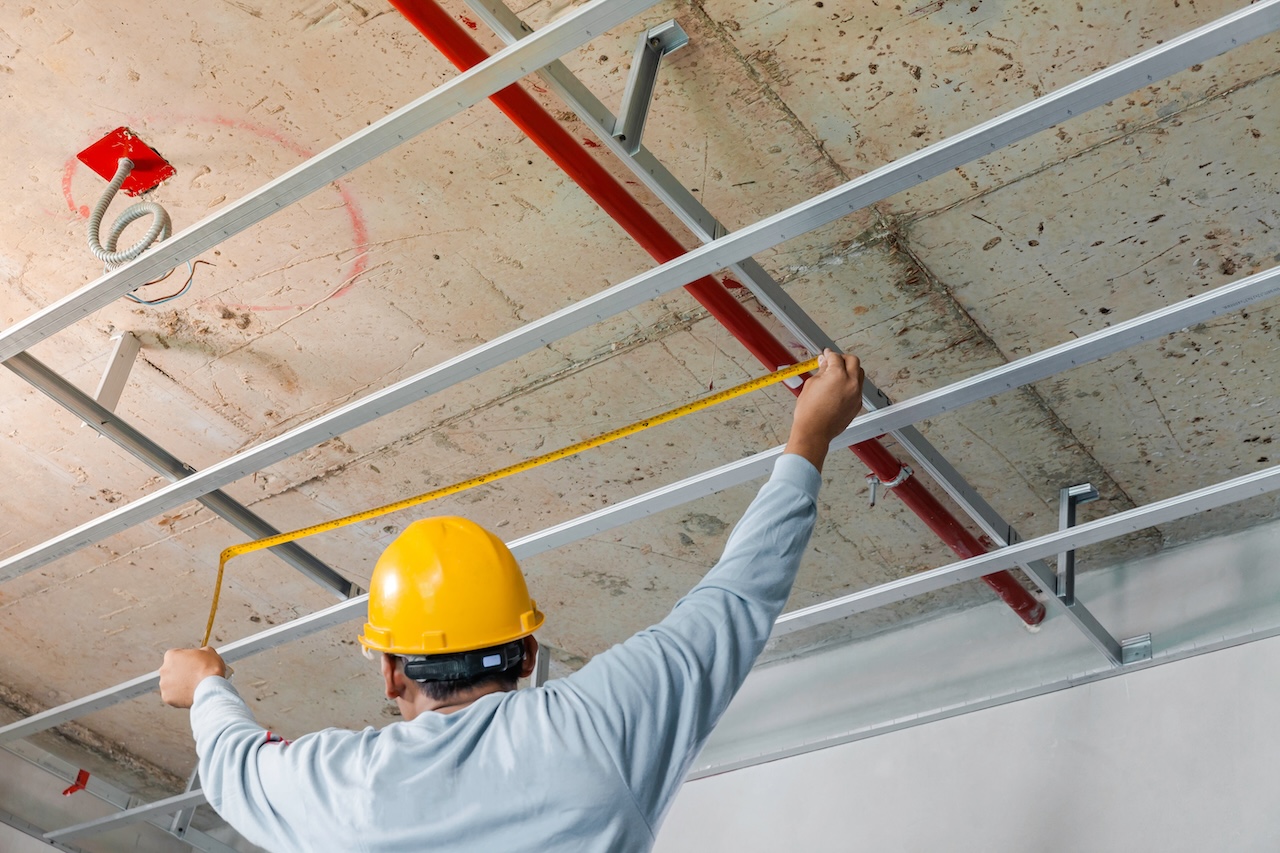 Measuring distance and planning the armstrong ceiling installation with acoustic panels With professional technicians